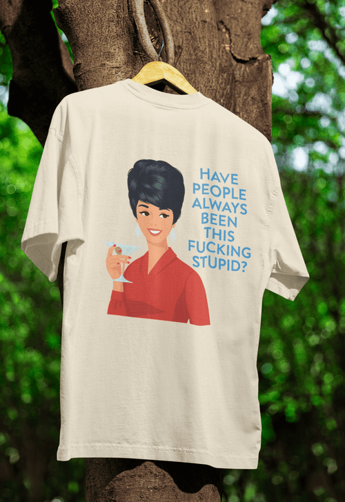 Natur-Creme T-Shirt mit Frau in rotem Kleid und Schriftzug Have-people-always-been-this-fucking-stupid im Barbie-Meme-Stil fuer Satiriker.